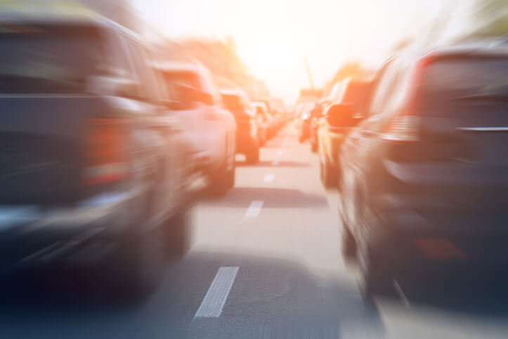 Evening traffic jam on busy city highway. Rows of unrecognisable car stuck on road due to crush accident. Sunset metropolis rush hour scene