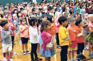 With hands over hearts, South Grove students recite the Preamble to the U.S. Constitution.