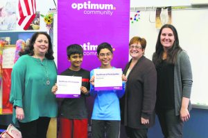 From left: South Grove enrichment teacher Michele Webb congratulates Aayan Subzwari and Russell Erfan, along with Principal Theresa Scrocco and Cablevision public affairs manager Kristen Thurber.