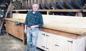 Syosset’s Ed Peterson standing by the new eight-foot cabinet he built to store tools and to use as a work surface. (Photos by Dagmar Fors Karppi)