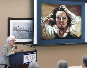 The residents of The Amsterdam at Harborside were mesmerized by a presentation given recently by Shirley Spector. The talk, entitled Artists Self-Portraits, featured works by many well-known painters including Gustave Corbet, who is shown in the photo above. Shirley Spector, a former docent at the Nassau County Museum of Art, is herself a resident of The Amsterdam at Harborside. (Photo by Edwin Hess) 