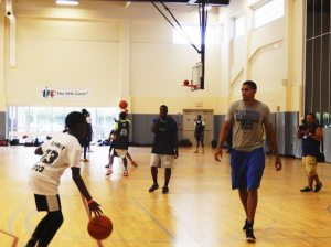 Tobias Harris runs drills with a young basketball player at the "Yes We Can" Center