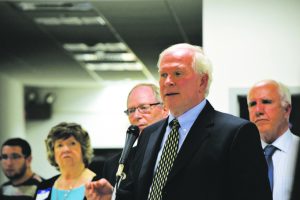 Robert Schick, at microphone, represented the state’s Department of Environmental Conservation. Just behind him were David Sobolow (left), who moderated the question and answer segement, and Joe DeFranco (right) of the Nassau County Health Department. (Photos by Frank Rizzo)