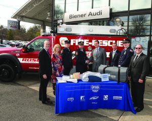 New York State Senator Jack Martins (sixth from left) and Assemblywoman Michelle Schimel (second from left) officiated as Biener Audi donated lifesaving CPR units to the Roslyn Hook & Ladder Company.