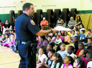 Officer Todd Aiken speaks to Dryden Street School students. 