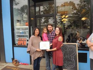 Town of North Hempstead Councilwoman Dina De Giorgio gives as owner Lauren Scheele proclamation from the town as daughter Ariana and William Sileo look on.