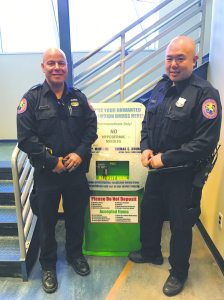 Nassau County Police Department POP Officers Rivera and Moy stand in front of the Third Precinct disposal box. Residents can dispose of unnecessary medications at any Nassau County Precinct or Police Center.