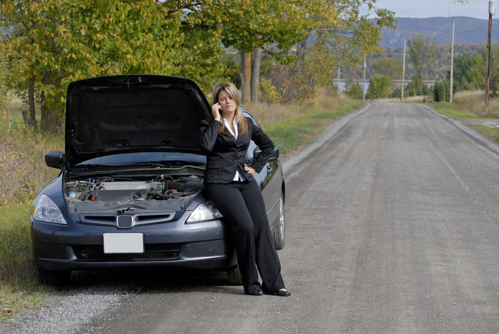 Businesswoman Sat On Her Broken Down Automobile At The Side Of T