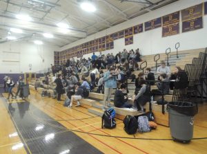 Students chowing down on the gym bleachers during the luncheon mixer portion of Career Day.