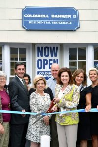 North Hempstead Town Clerk Wayne Wink, Coldwell Banker Residential Brokerage Port Washington Office Manager Gracene Gardella, President Laura Rittenberg and Executive Vice President of Northeast and Eastern Seaboard Regions of NRT LLC Maureen Passerini, along with affiliated sales associates in front of the new Port  Washington office.