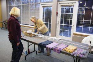 Patricia Forte and Judy Lambert use the weaving machine