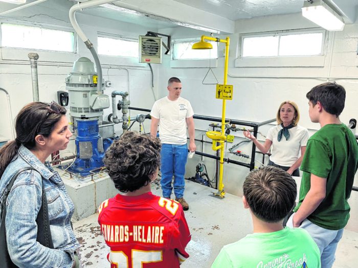 Port Washington Water District Commissioner Mindy Germain, back right, leading a student tour of a Port Washington Water District plant alongside Field Supervisor Jasper Skliba, back center