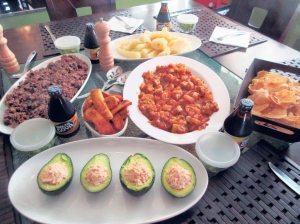 Moros, boiled yucca, fried plantains, grilled shrimp in a wine and mango salsa sauce, chips and avocado stuffed with seafood. 