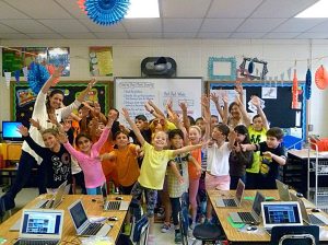 Manorhaven Elementary School 4th-grade teacher Lynette O’Donnell (left) with paraprofessional Alice Uchiyama and students raise awareness for pediatric cancer.