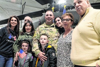 Army Specialist Alfred Staab and his wife Stephanie pose with their families at the Deployment Ceremony on Jan. 22
(Photo by Cory Olsen)