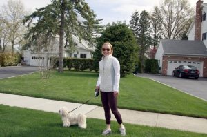 Carolyn Moore walks one of her clients' dogs. 