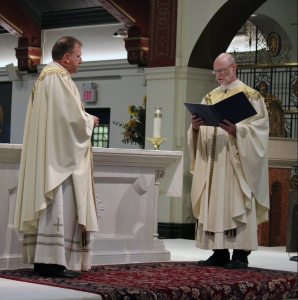 The Very Reverend William T. Slater, Dean of the North Hempstead Deanery (Diocese of Rockville Centre) reading the Proclamation of Appointment before presenting the Pastor-Elect to the parish community.