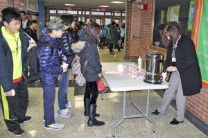 South Middle students line up for a cup of cocoa during the annual Cocoa Sale fundraiser. (Photo by Deidre Elzer-Lento)