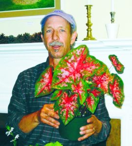 Bill Erdmann surrounded by “Thrill” plants that set the color, mood and design of a container garden. (Photo by Jane Doctors)