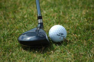 golf_ball_resting_near_fairway_wood