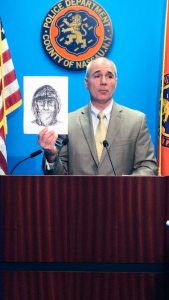 Nassau County Police Department Detective Lt. Richard LeBrun holds up a police sketch of the suspect. 