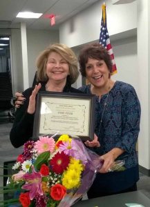 Great Neck Library Board of Trustees President Marietta DiCamillo (right) presented outgoing Treasurer Josie Pizer with a certificate of appreciation and flowers at the Jan. 17 Board of Trustees meeting.