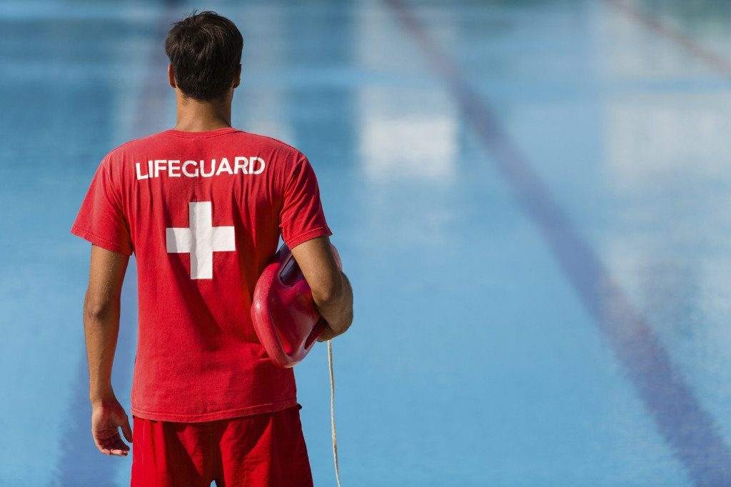 Lifeguard watching swimming pool