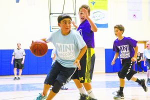 At left, Luke Cronin of Sid Jacobson JCC Maccabi Team has the ball.