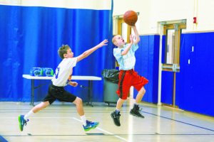 At right, Braden Sosnick of the Sid Jacobson JCC Maccabi Team shoots.