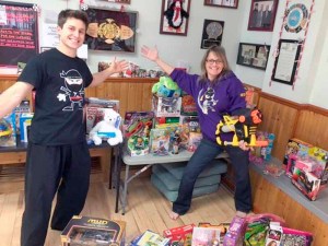 Messina (with student Chris Trietsch) helped collect toys at Taecole for the less fortunate. Every Christmas, Messina spends the day distributing the toys to children. 