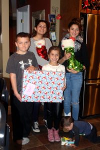 Jake Delio, Gianna Marasco, Amanda Marasco, Nina Marasco and Gio Marasco help the McAngels pack gifts. 