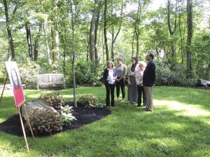 The Reichenbach family and  Mayor Elaine Phillips view the memorial plaque and Morning  Glory Maple planted in honor  of Karen Reichenbach