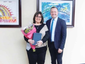 Retiring clerical secretary Janet Rutkowski receives warm wishes from Principal James Murray. (Photo by Steve Mosco)