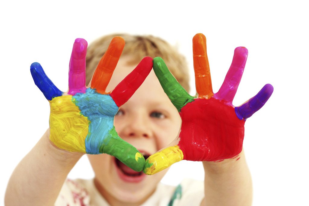 Happy child with painted hands