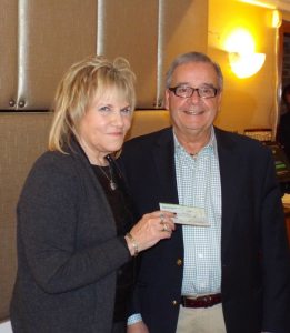 Manhasset Rotary President Esther Miller (left) presenting a $500 check to Tony D'Urso, representing Cross Cultural Thresholds.