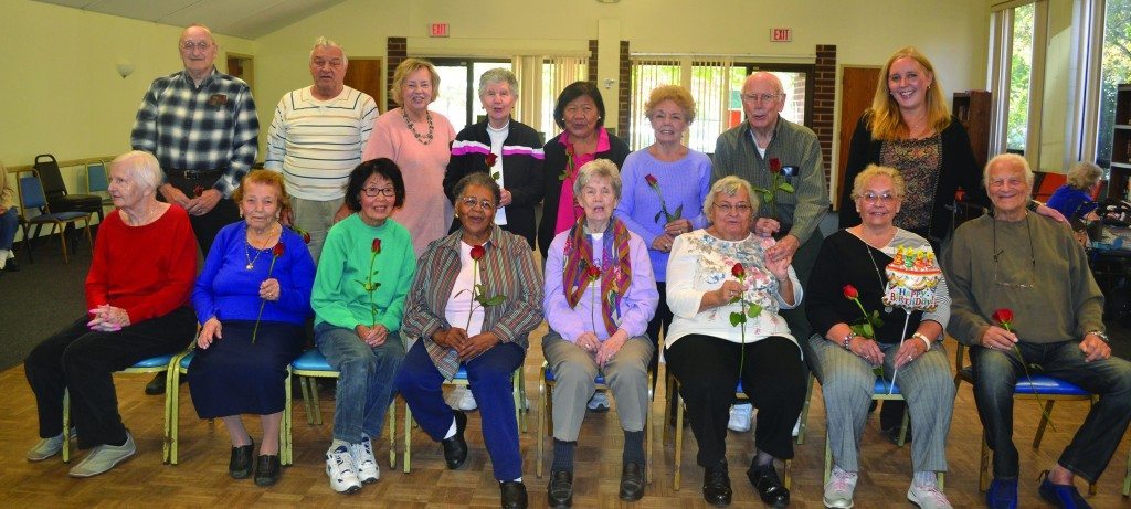 Senior Center fall birthday babies celebrate their special day with Legislator DeRiggi-Whitton (right, standing)