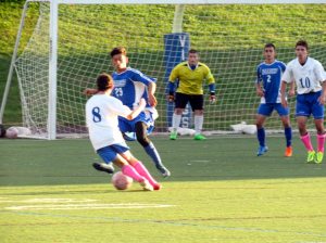 Vikings defender Daniel Ernst (8) tries to get around Yianni Nictas (29) as midfielder Steven Sandoval (10) parks himself in front of the net looking for a pass.