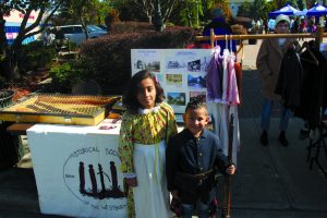 Students dressed up in old-time fashions at the Historical Society of the Westburys booth.