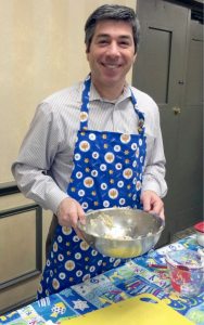 Rabbi Todd Chizner stirring up  latke batter