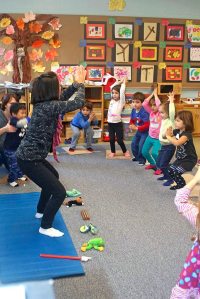 Dena Vigilis of Little Lotus Yoga teaches children Claire Salerno, Ben and Hailey Tanguay and Erin Moleski yoga poses.