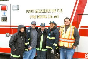 Members of the Port Washington Fire Department Fire Medic crew on standby at the finish line