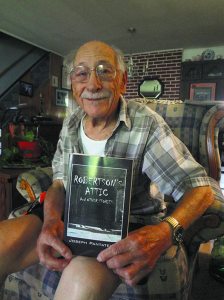 Guild cofounder and Levittown  resident Joe Pantatello showing off his short story anthology Robertson’s Attic.