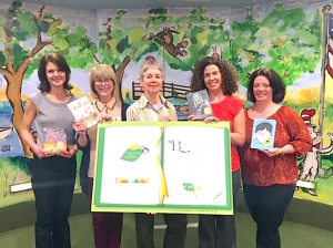 Children’s Library staff with a bookplate