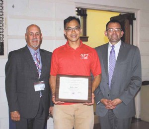 Sewanhaka High School career and technical education teacher Jack Chen (center) is picoted with Superintendent of Schools Dr. Ralph Ferrie (left) and Principal Dr. Christopher Salinas.  