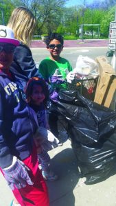 Bellerose Terrace mom Jill Popolizio bagging up trash with help from her two children and a friend