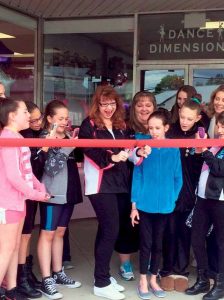 Director Eileen Wangner is surrounded by her students at the Dance Dimensions ribbon-cutting ceremony.