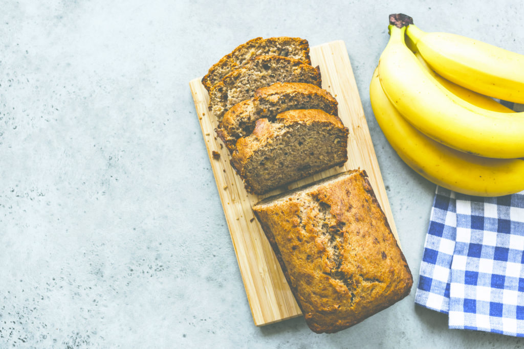 Banana bread loaf on concrete background top view