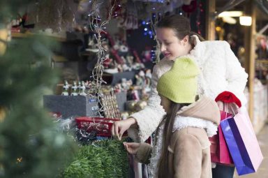 Mother with daughter in Christmas market