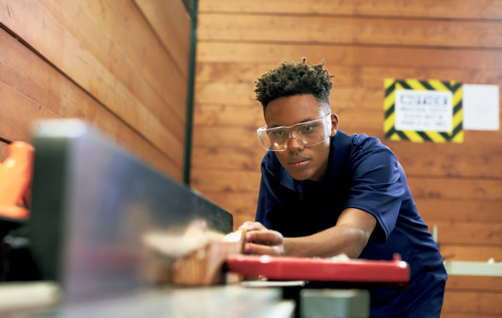 Carpenter Using Plane In Woodworking Woodshop