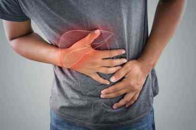 The photo of large intestine is on the man’s body against gray background, People With Stomach ache problem concept, Male anatomy